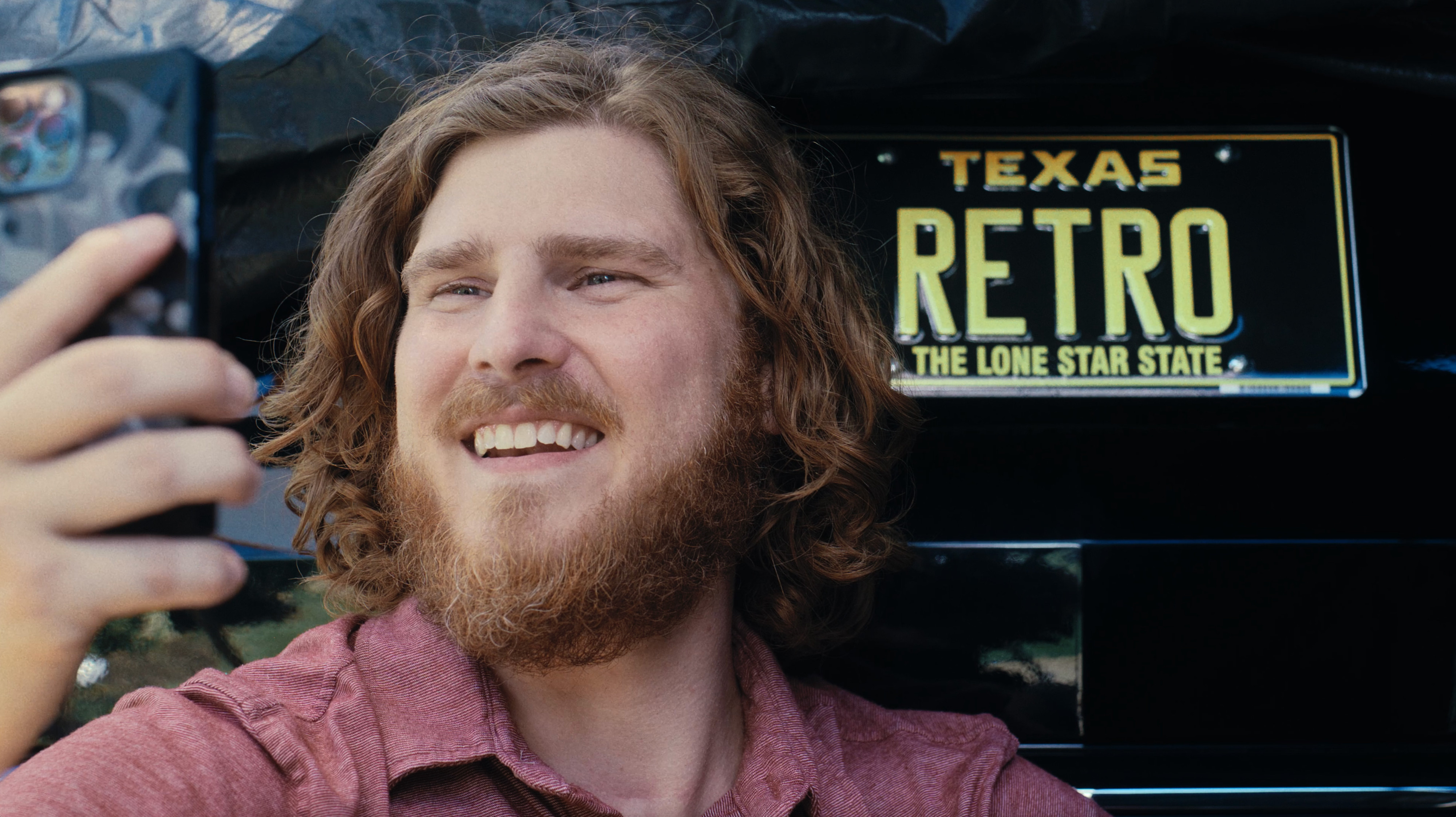 Man taking a selfie with a RETRO license plate