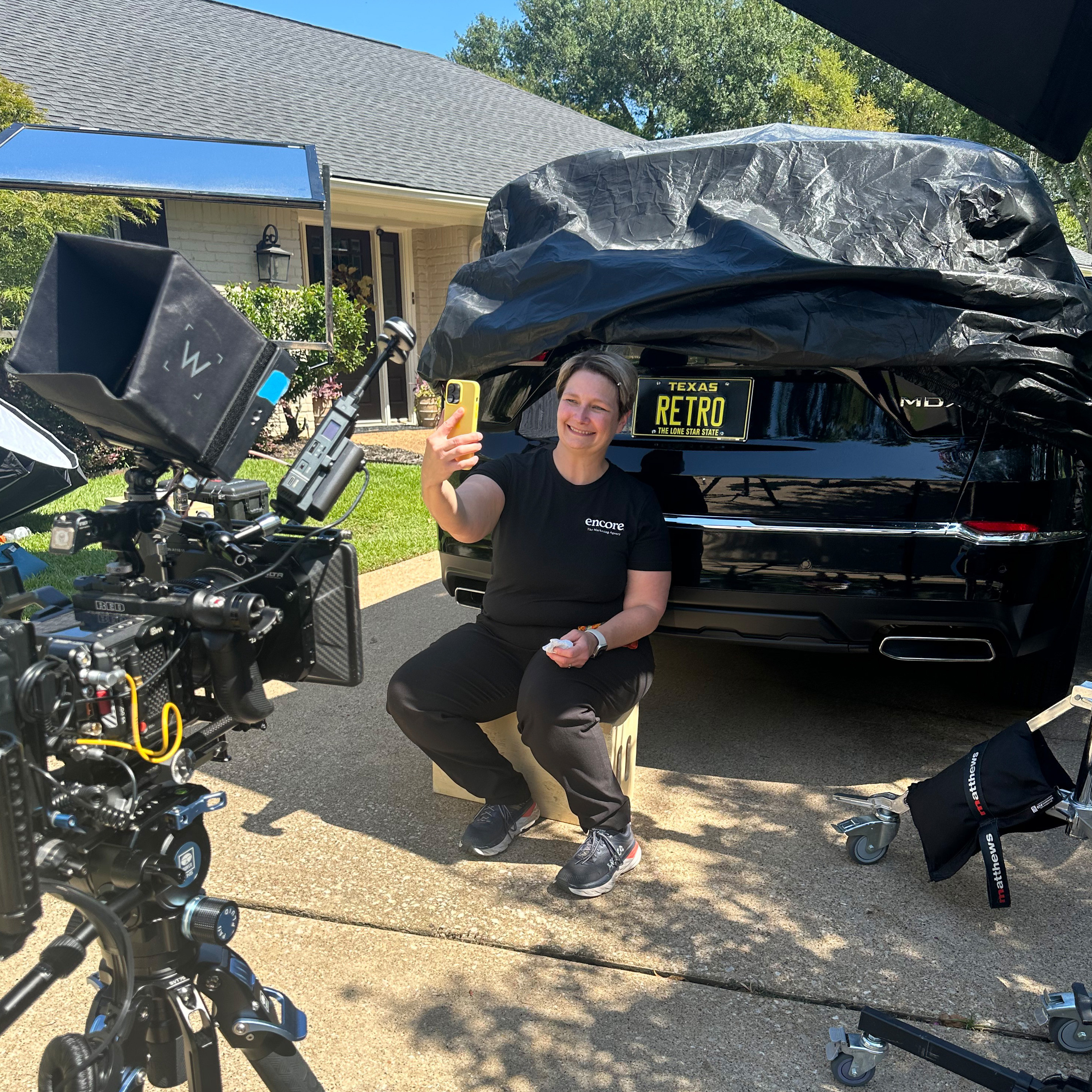 Team member, Jennifer, staging the selfie shot with the RETRO license plate